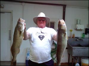 Richard Creque of Napoleon, Ohio, shows off walleye he took from Lake Erie, together topping 13 pounds.