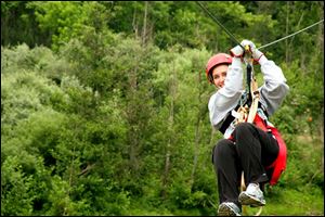 Ride a zipline  at The Wild Zipline Safari in Muskingum County.