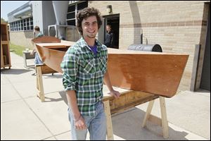Aaron Zimmerman shows off the 13-foot mahogany boat that he built as the final project for his cabinetry class at Bedford Senior High School.