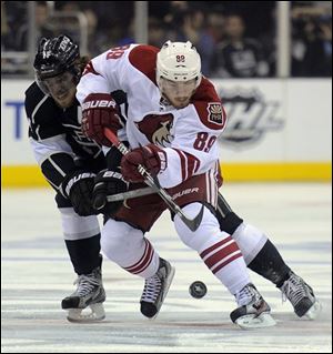 Kings center Anze Kopitar, left,  and Phoenix Coyotes right wing Mikkel Boedker battle for the puck during the first period in Game 4.