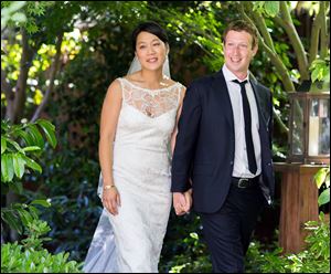 Mark Zuckerberg, Facebook founder and CEO, and his longtime girlfriend, Priscilla Chan, pause at their wedding. The fewer than 100 guests at the Saturday event thought they were invited to a graduation party for her.