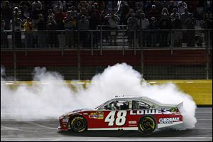 Jimmie Johnson does a burnout to celebrate winning the NASCAR Sprint Cup All-Star race Saturday night.

