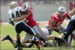 Ohio State’s Andrew Sweat tackles Akron’s Jawson Chisholm. He led OSU linebackers with 72 tackles in 2011. Sweat has been accepted to five law schools.


