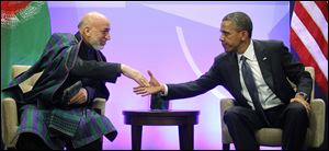President Obama shakes hands with Afghan President Hamid Karzai during their meeting on the first day of the NATO summit in Chicago.
