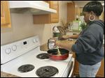  Paris May, 23, cooks a scrambled-egg dish at Seagate Food Bank’s cooking class. Ms. May said she knows how to cook but has mostly prepared fried foods.