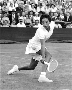 In this June 26, 1956 photo, trailblazing tennis star Althea Gibson competes in the first round of Wimbledon, in England.