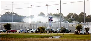 Smoke rises above the Adams County Correctional Center in Natchez, Miss., Sunday, during an inmate disturbance at the prison.