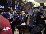  In a photo made May 7, 2012,  trader John Vaccarine, right, works on the floor of the New York Stock Exchange in New York.  Wall Street was headed for a slightly lower open on Tuesday May 22, 2012, with Dow Jones industrial futures marginally down.  (AP Photo/Richard Drew)