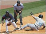  Hens third base player Audy Ciriaco gets the ball but not before the Chiefs' Brett Carroll slides in safely.