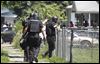  CTY swat24p  Members of the Toledo Police Department SWAT move into a home after a shooting on Bricker near Doyle, May 23, 2012. The Blade/Andy Morrison