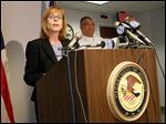  Carole Rendon, 1st Assistant U.S.Attorney, discusses the charges filed against 18 people stemming from raids last fall at a number of area IHOP restaurants, during a news conference at the U.S. Attorney's office in Toledo.  Deputy Toledo Police Chief George Taylor is at back right.  A majority of  the charges are for money laundering, harboring of illegal immigrants, and identity theft.