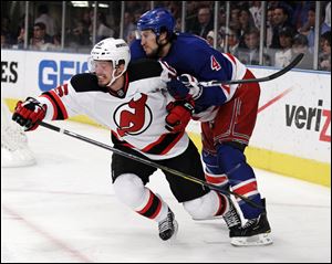 New Jersey Devils' Jacob Josefson, left, and New York Rangers' Michael Del Zotto struggle for position during the first period of Game 5.