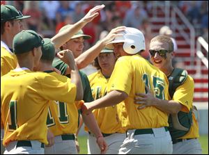Tyler Brown is greeted by teammates after scoring against Southview in the district final. Brown led Clay at the district by going 4-for-6 with two doubles.