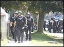 Members of the Toledo Police Department SWAT prepare to move into a home after a shooting on Bricker near Doyle.