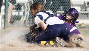 Notre Dame catcher Emily Dzierzak tags out North Royalton's Laura Weible on a throw from center fielder Molly Walters to end the eighth inning in a Division I semifinal.