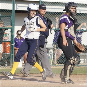 Notre Dame's Jenna Inman scores on an infield single by Molly Walters to give the Eagles a 6-4 lead as North Royalton catcher Lauren Oster watches in the 10th inning in Thursday's Division I regional semifinal.