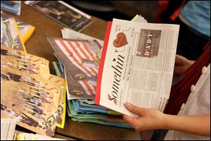 Staff members choose extra issues of the Somethin' for keepsakes. According to lore, the newspaper got its name almost a century ago when a student said that they had to name it 'somethin'.'