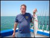  John Deem of Canton shows off the lake trout he reeled in while on an outing in western Lake Erie. The laker usually shuns shallow water.