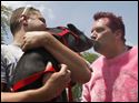 Jack Renz, the principal at East Broadway Elementary School, kisses Ned, a miniature pig, in front of the entire student body outside of their Toledo, Ohio school. The kiss is a result of the students exceeding their reading goal, totaling 30,783 pages. Holding the pig is Ned's owner, Lester Marks, of Monroe, Mich.