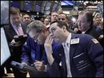  FILE  - In a Dec. 9, 2011 file photo specialist Michael Gagliano, foreground right,  works at a post on the floor of the New York Stock Exchange. Wall Street appeared set for a higher open, Friday May 25, 2012 with Dow Jones industrial futures rising 0.2 percent to 12,558 and S&P 500 futures gaining 0.3 percent to 1,326.20. (AP Photo/Richard Drew)