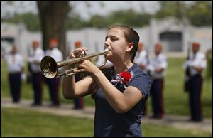 Amanda Blossom plays 'Taps' after a 21-gun salute from the Marine Corps during the Waite High School Memorial Day program.