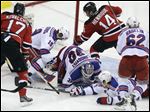  The Devils' Adam Henrique (14) scores on Rangers goalie Henrik Lundqvist just 63 seconds into overtime of Game 6.