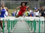  Brianna Scott Glover of Rogers, center, wins the 100 hurdles over Anthony Wayne’s Aisha Potts-Tyre, left, and Melody Farris of Lorain.