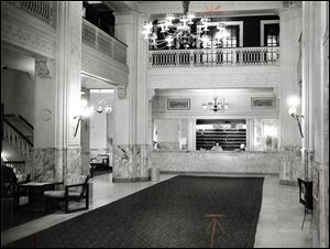 A clerk works at the desk in the empty lobby of the Waldorf Hotel in November, 1977.