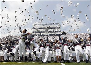 Cadets throw their hats in the air to conclude a graduation and commissioning ceremony at the U.S. Military Academy in West Point, N.Y.