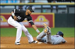 Cleveland Indians' Shelley Duncan, right, steals second base as Chicago White Sox shortstop Alexei Ramirez tries to make a tag during the second inning of a baseball game on Friday.