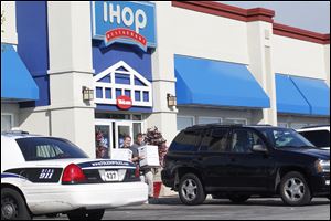 Authorities take boxes out of IHOP on Talmadge in West Toledo last September.