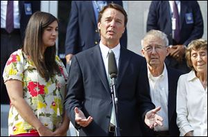 John Edwards, second from left, speaks outside a federal courthouse as his daughter Cate Edwards, left, and parents Wallace Edwards, second from right, and Bobbie Edwards, right, look on after the jury's verdict in his trial on charges of campaign corruption in Greensboro, N.C..