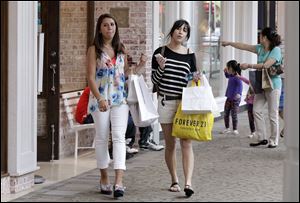 Shoppers visit the South Shore Mall in Braintree, Mass. Consumers spent more at retail stores in May than in the same month in 2011. They bought more clothes and more Mother's Day gifts.