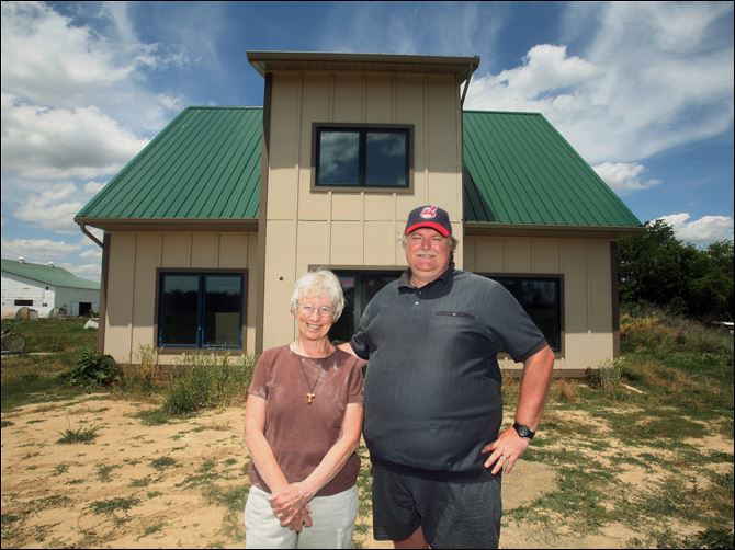 Sister Jane Francis Omlor Mike Connor straw-bale house Sister Jane Frances Omlor and Mike Conner, director of the Sisters of St. Francis of Tiffin’s Earth Literacy Center, pose in front of the eco-friendly, energy-efficient straw-bale house.
