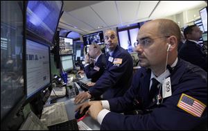 Traders work on the floor of the New York Stock Exchange Monday.
