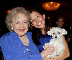 Actresses Betty White, left and Wendy Diamond hold Lucky Diamond. The fifteen-year-old Maltese who the Guinness Book of World Records credited was the animal photographed with the most famous people, died at her home in New York on Tuesday, June 5, 2012 of spleen cancer.
