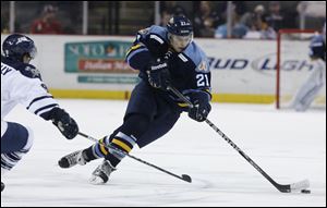 Walleye player Bryan Rufenach skates the puck up the ice against the Greenville Road Warriors in January.