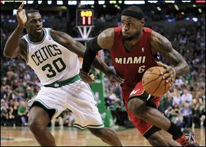 Miami Heat forward LeBron James (6) drives against Boston Celtics forward Brandon Bass (30) during the third quarter in Game 6 Thursday n ight.