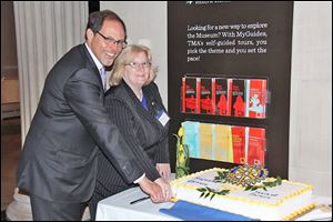 Club president David Czerniak and club president-elect Susan martin cut the cake to celebrate the Rotary Club of Reynolds Corners' 50th anniversary in the Cloister at the Toledo Museum of Art.