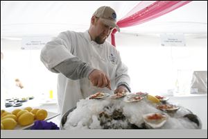 Rob Campbell, formerly the chef at Bluewater Grille in Maumee, prepares oyster shooters with tequila gazpacho during a Taste of the Nation event in 2010. On Tuesday, Mr. Campbell will open his own restaurant, Revolution Grille, at 5333 Monroe St.