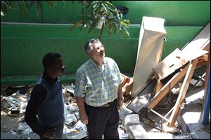 Bishop Bruce Ough walks through an earthquake-damaged building in Haiti.  The United Methodist Church's West Ohio Conference has forged ties in 'the four corners of the world.' 