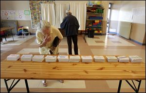 A French citizen looks at ballots paper before voting, in a polling station in Nice, southern France, in the first round of the French parliamentary elections to elect the 14th National Assembly of the 5th Republic.