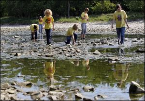 Volunteers from the Toledo ZooTeens, in conjuction with Partners for Clean Streams, search the Maumee River to remove fishing lures made of lead.