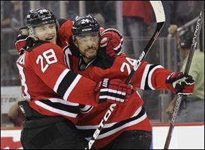 New Jersey's Bryce Salvador, right, celebrates with Anton Volchenkov after scoring a goal in the second period. Salvador's goal stood as the 2-1 winner over Los Angeles, keeping the Devils in the hunt.