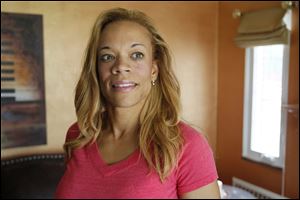 Erika D. White in her home in Toledo.  She reconnected with her birth mother through Catholic Charities Search and Reunion program and is now searching for her father.