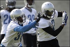 Detroit Lions defensive backs Ross Weaver, left, and Amari Spievey drill during NFL football practice in Allen Park, Mich.