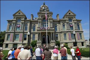 A crowd surrounds Tom Davis as he leads a tour of the 1888 Hancock County Courthouse. Tours continue every hour on the hour from 11 a.m. to 3 p.m. through Friday, with additional tours on Thursday.