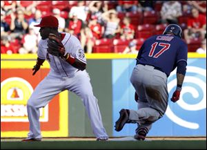 Cincinnati Reds' Brandon Phillips waits for the throw from the outfield as Cleveland Indians' Shin-Soo Choo makes it to second base on a double in the first inning during their interleague baseball game in Cincinnati, Tuesday.