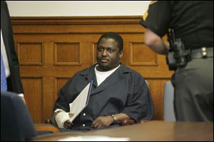 Wayne Powell awaits the judge for his sentencing in 2007.