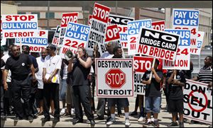 The announcement of a planned second bridge over the Detroit River linking Canada and the United States drew protesters in  Detroit, where the deal was signed Friday